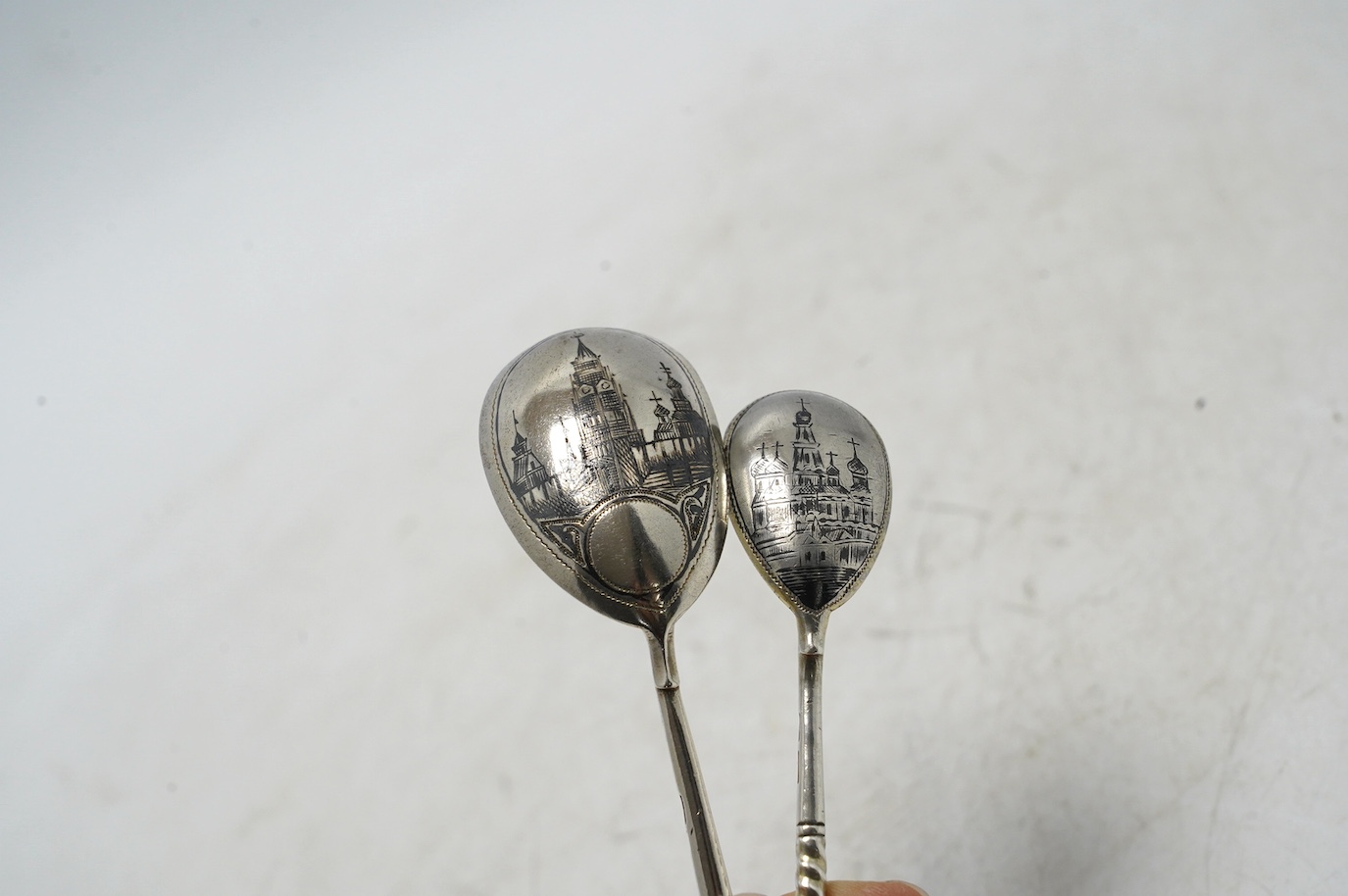 A pair of late 19th century Russian 84 zolotnik serving spoons, Moscow, 1896, 18.8cm, and two other smaller Russian 84 zolotnik and niello spoons. Condition - fair